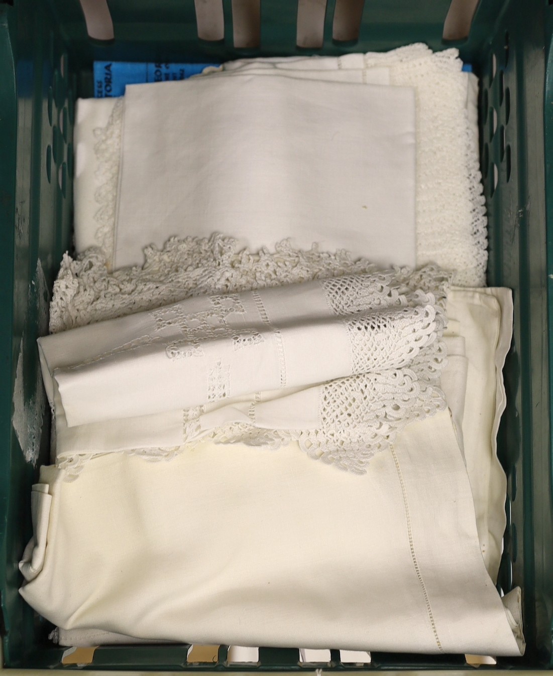 A quantity of lace trimmed and embroidered fabrics including tray cloths and pillow cases